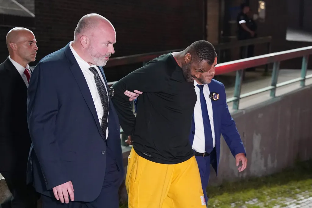 Michael Foster being transported from the NYPD 47th Police Precinct stationhouse.