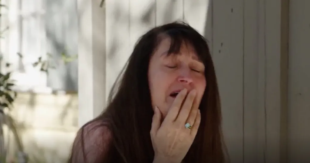 Debby from 90 Day Finance crying with her hand covering her mouth.