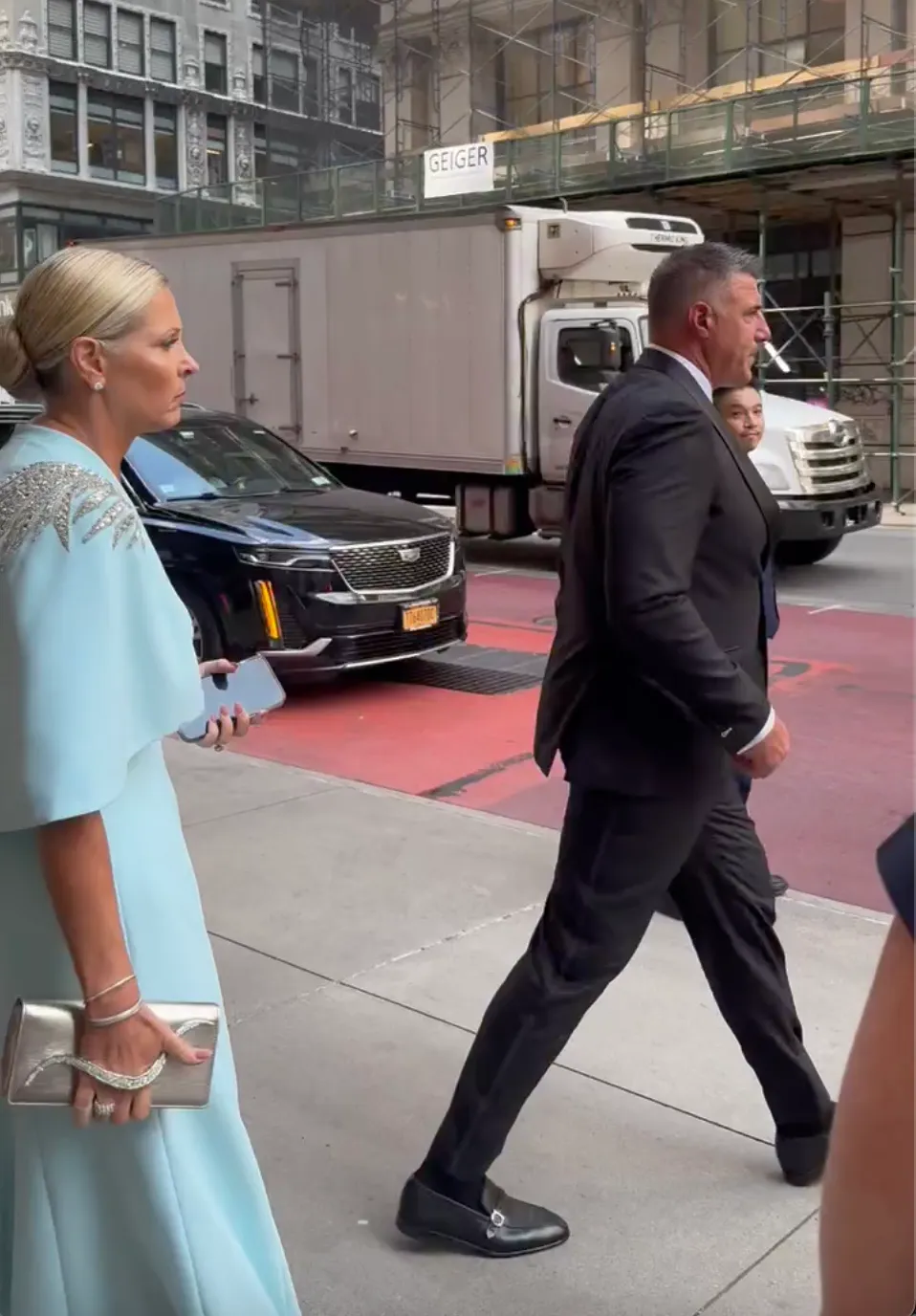 Jen Vrabel and Mike Vrabel walking down a street in New York City.