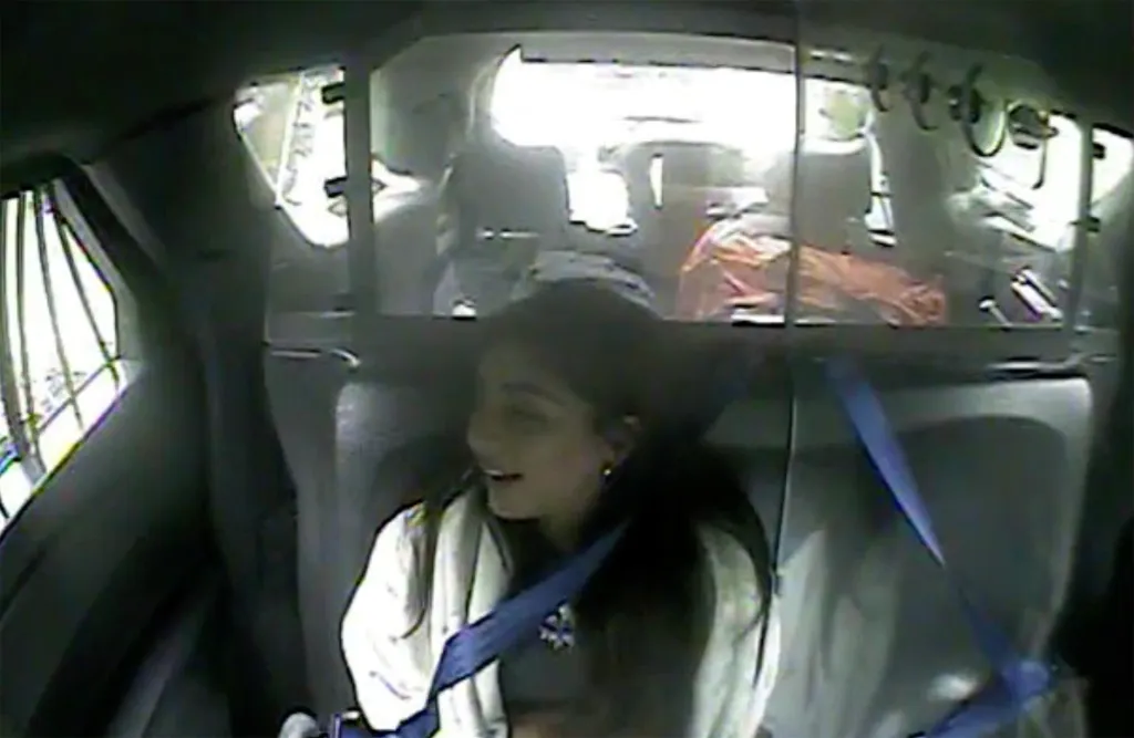 Milania Giudice in the backseat of a vehicle, captured by a bodycam.