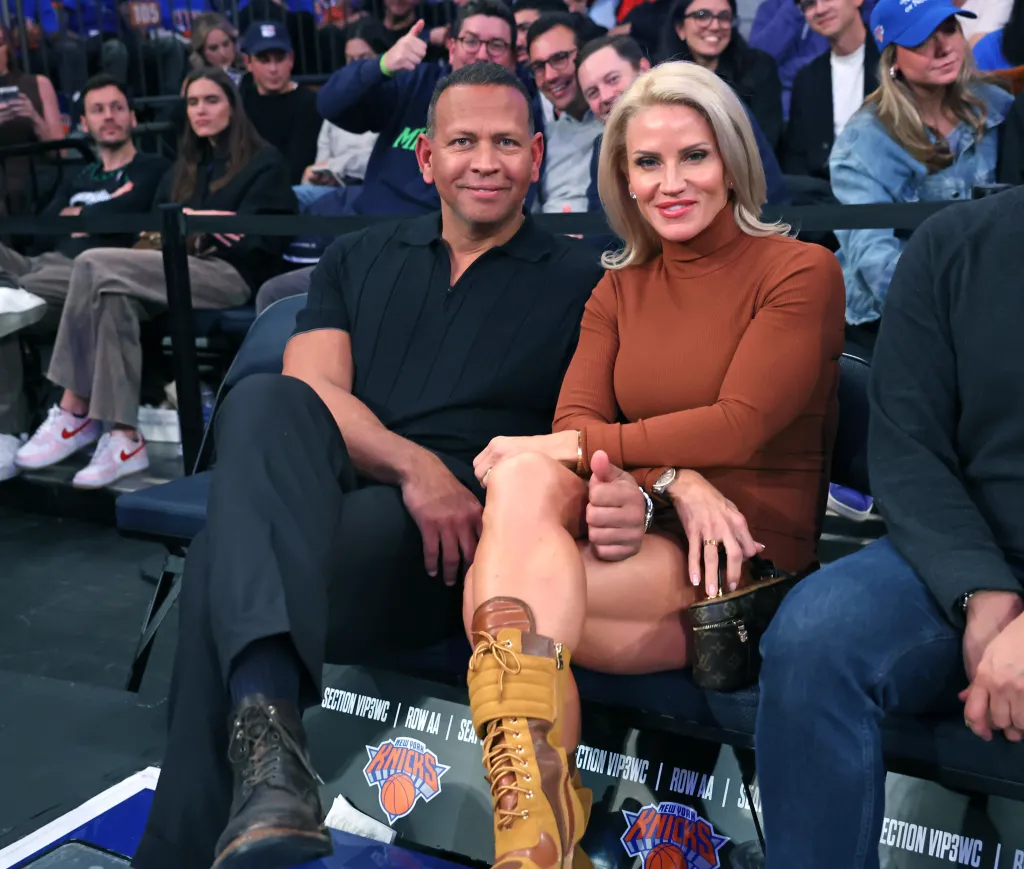 Alex Rodriguez and Jaclyn Cordeiro smiling courtside at a New York Knicks game.