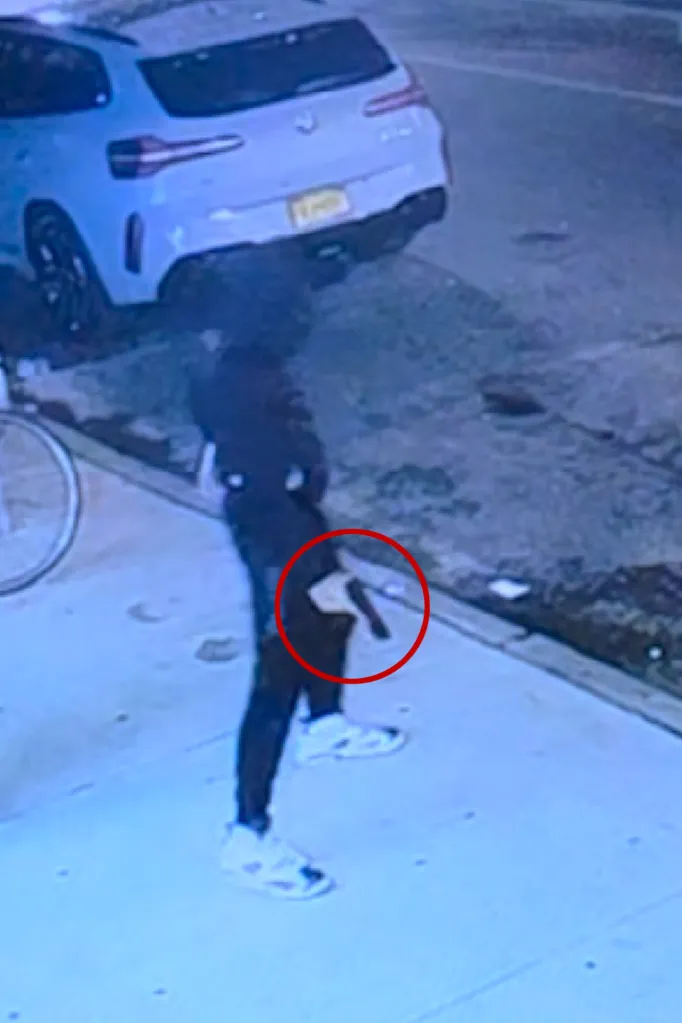 Surveillance footage of a person loading the chamber of a handgun.