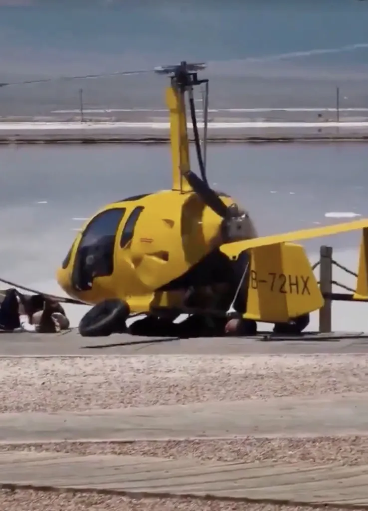 Yellow gyroplane crashed onto two tourists.