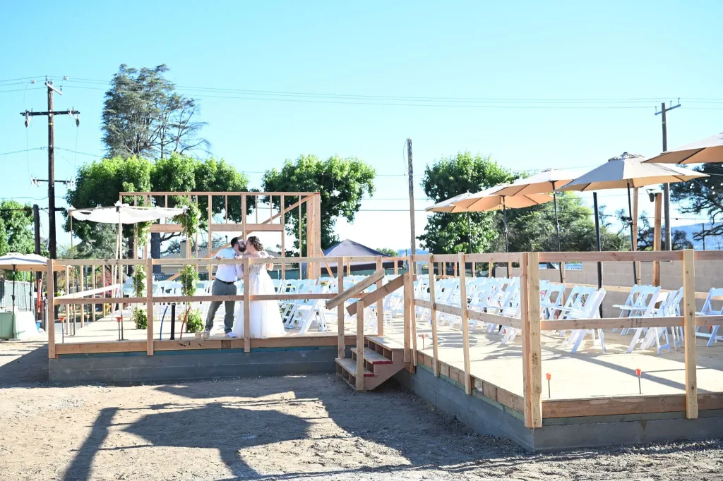 Morgan Soloway and Kenny Rotter kiss at their wedding ceremony on the lot where they are rebuilding their home after losing it to the Eaton Fire.