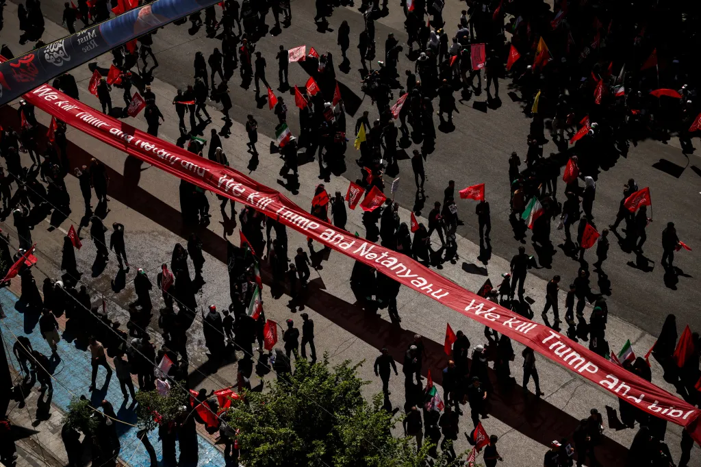 Mourners carry a banner against U.S. President Donald Trump and Israeli Prime Minister Benjamin Netanyahu during the burial of Iran's late Supreme Leader Ayatollah Ali Khamenei.