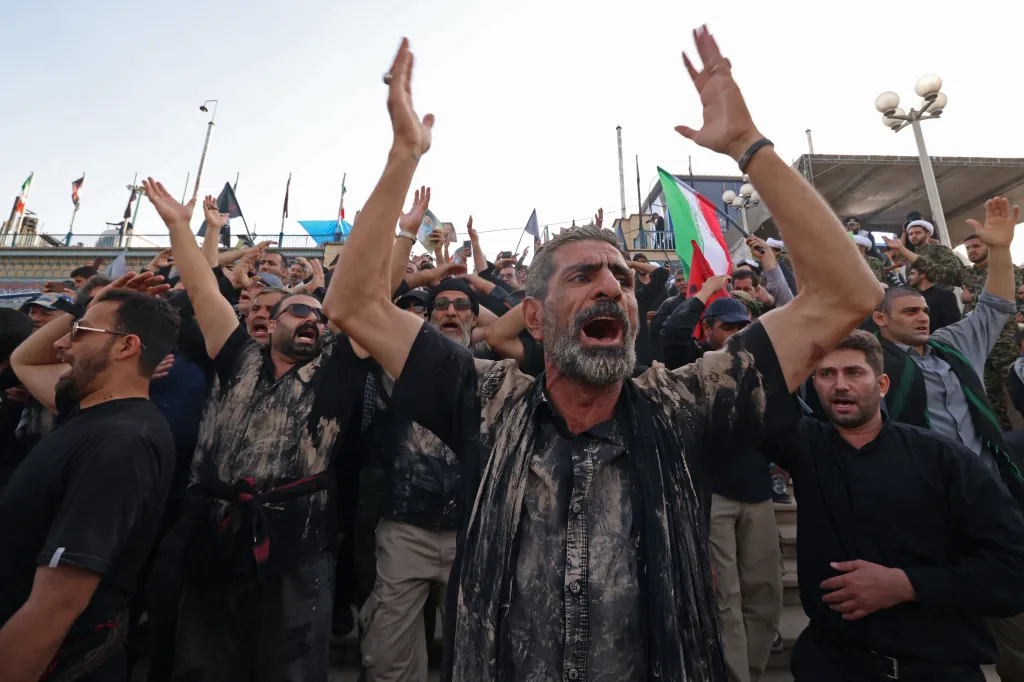 A man shouts slogans while paying respects to Ali Khamenei.