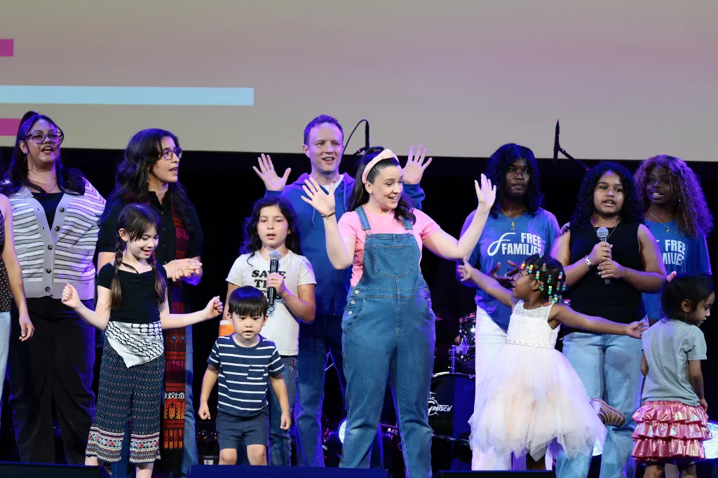 Ms. Rachel and The Peace Poets performing on stage with several children at the Committee for the First Amendment Concert.