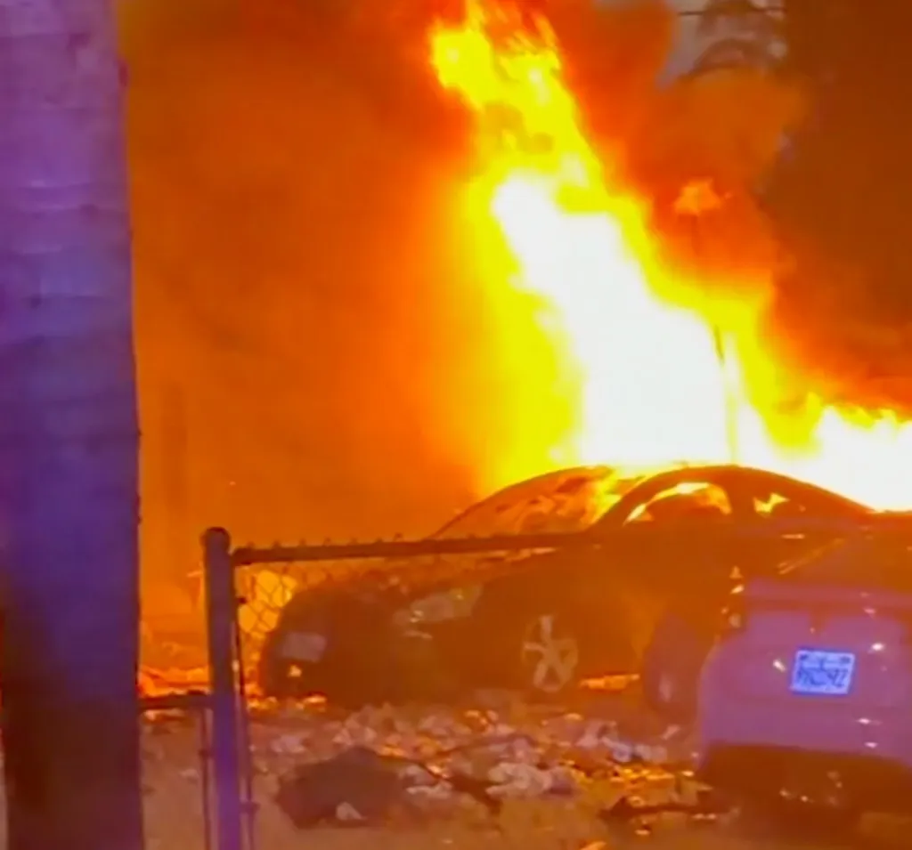 A car fully engulfed in flames from a fireworks accident in Chino.