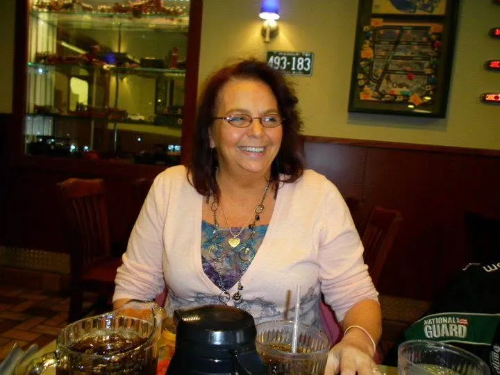 Amy Steadman, mother of Sarah Myers, smiling at a restaurant table.