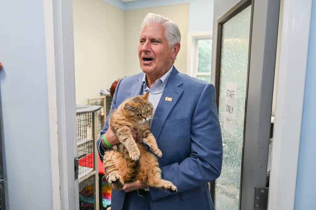 Nassau County Executive Bruce Blakeman holding a large tabby cat.