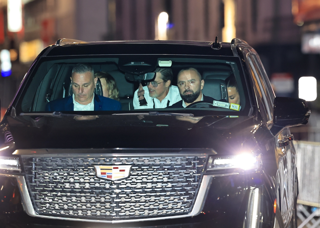 Brad Pitt, Ines de Ramon, and Beck departing Taylor Swift and Travis Kelce's wedding in an SUV.