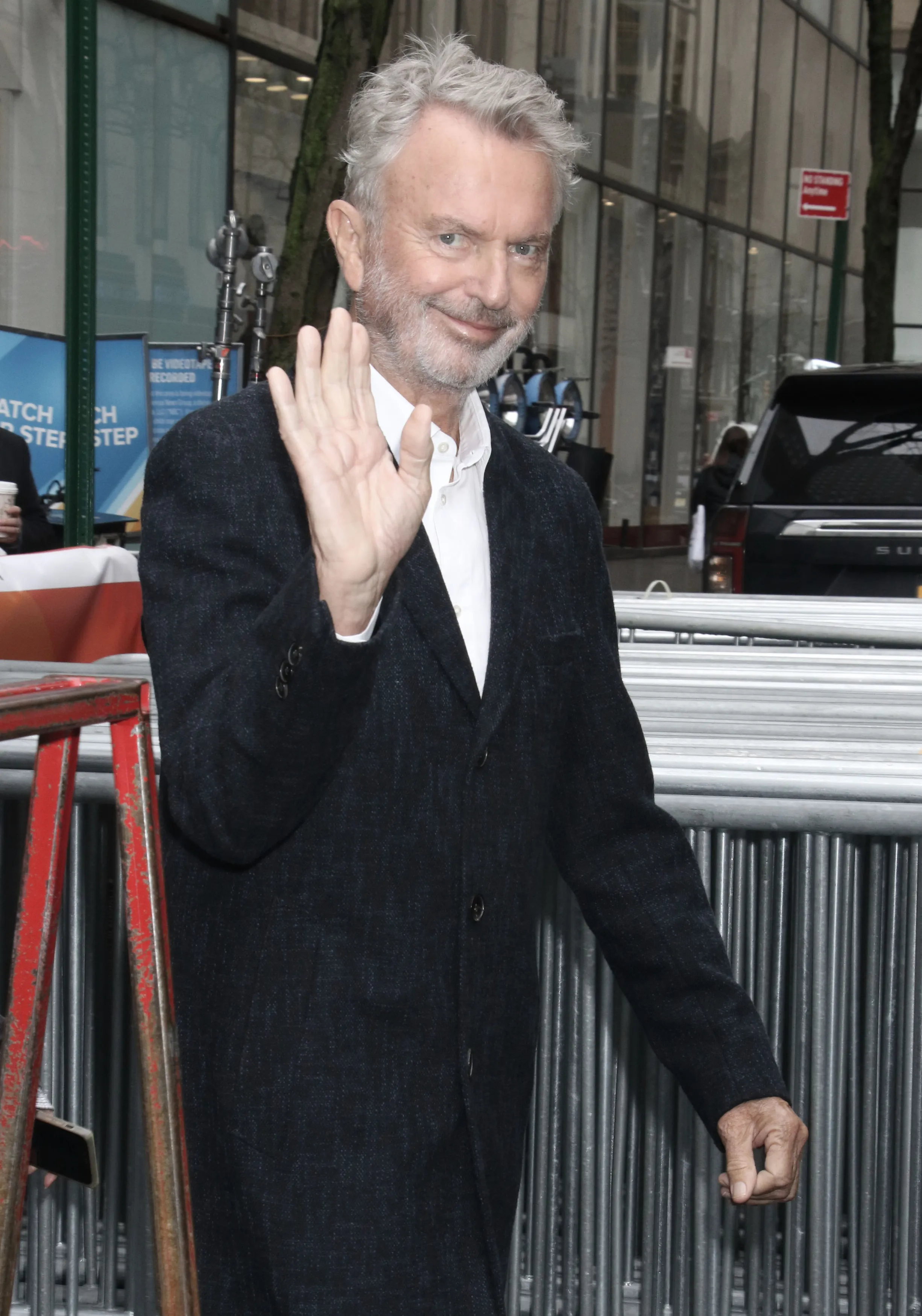 Sam Neill waving.