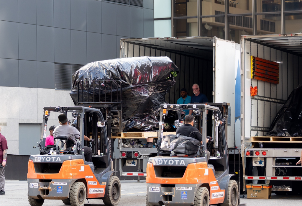 Forklifts move materials for an event at Madison Square Garden.