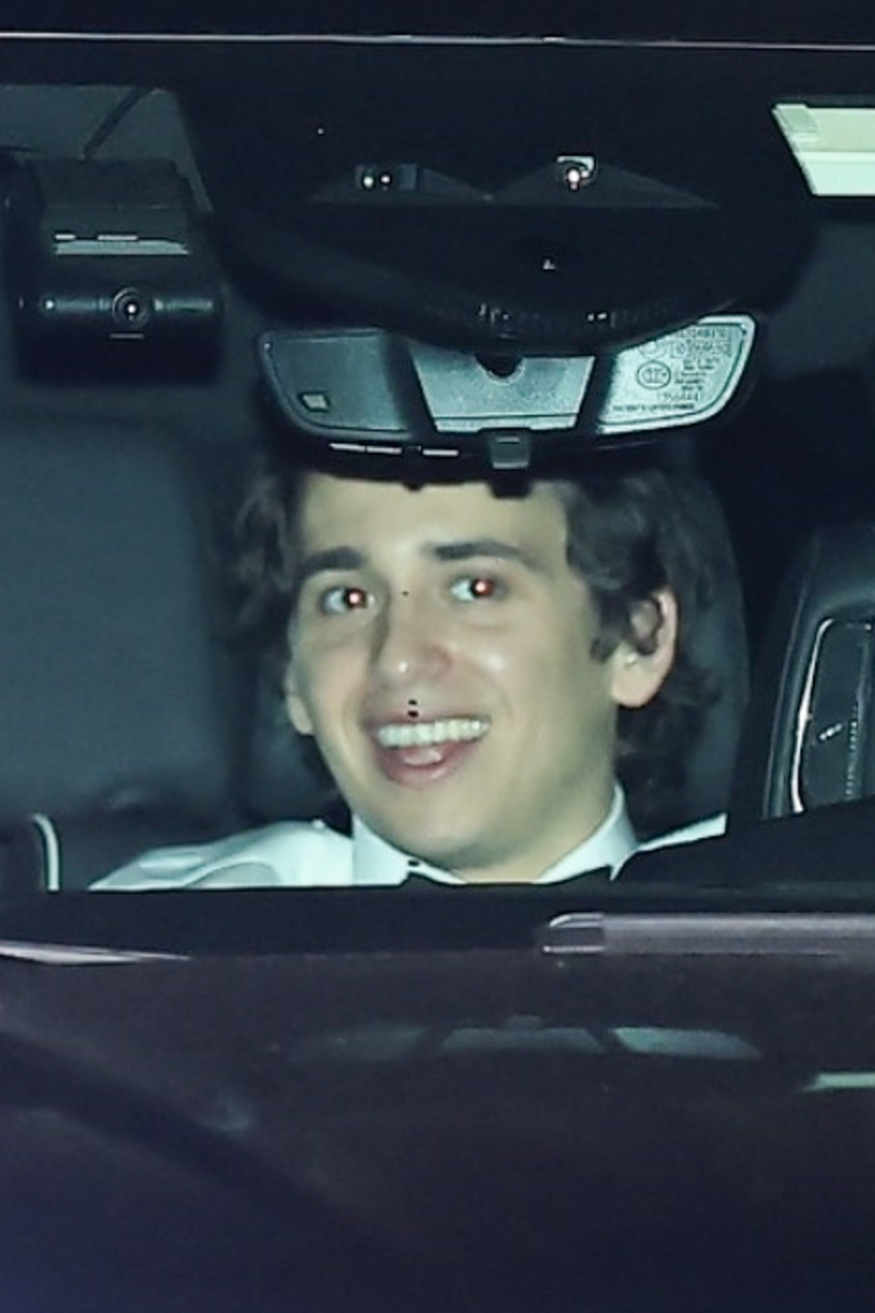 Marcello Hernandez smiles in the backseat of a car.
