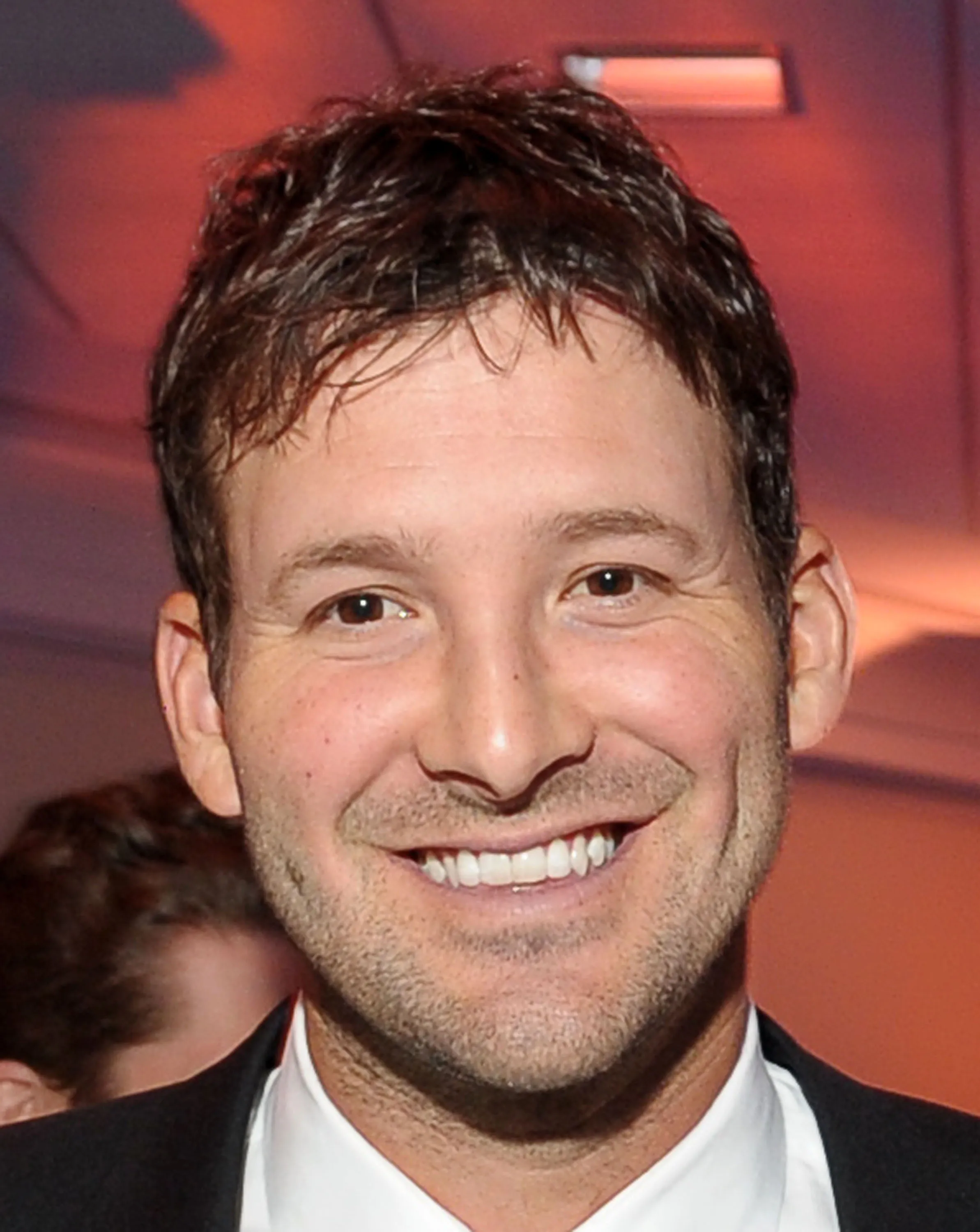 NFL player Tony Romo smiling.