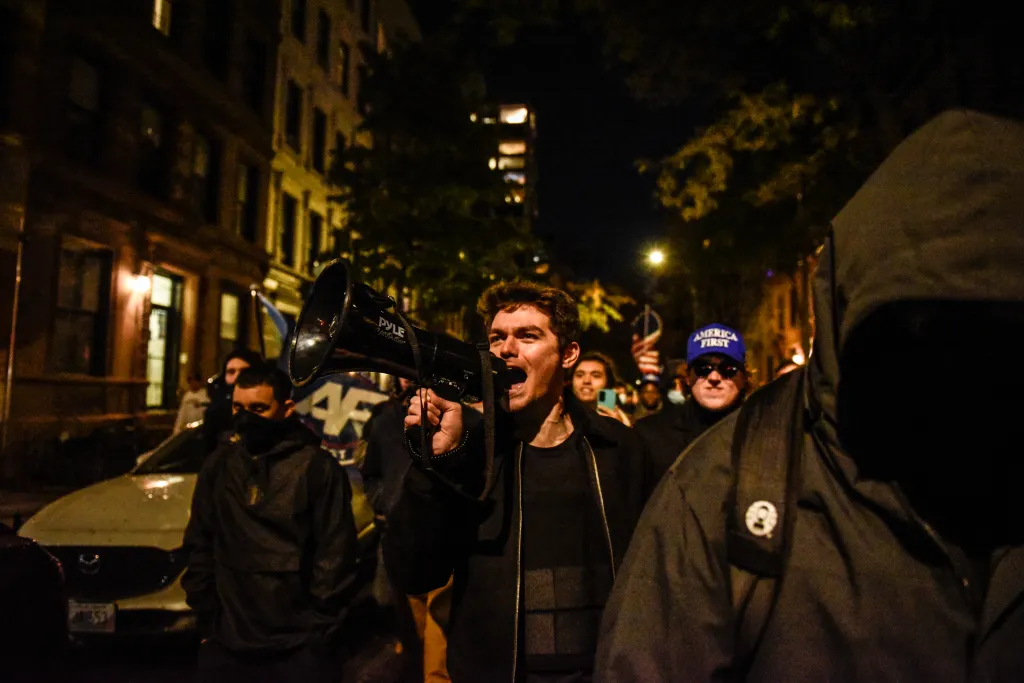 Nicholas Fuentes marching through streets 