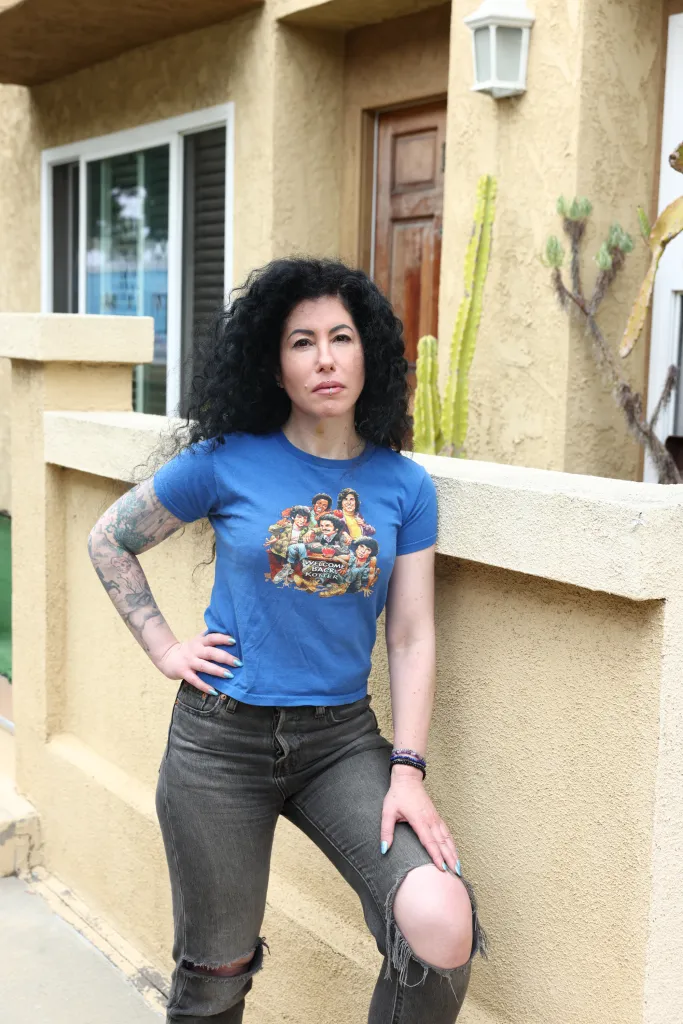 Nikki Dobrin, whose home insurance policy was canceled, poses at her condo.