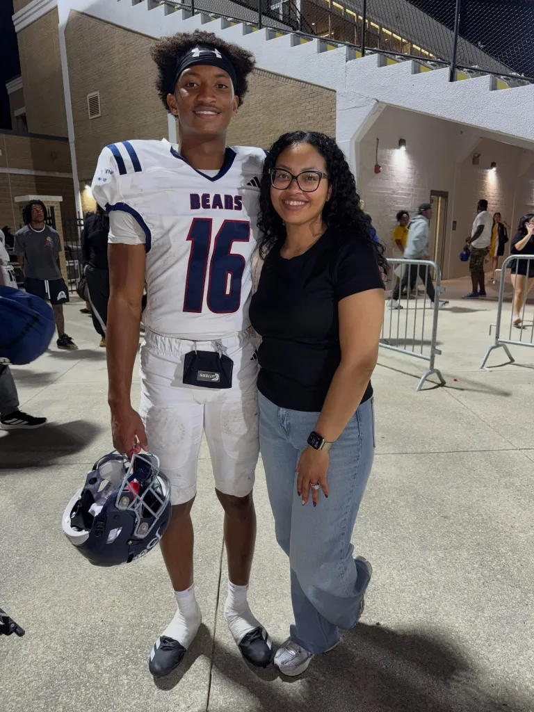 Nolan Wells in his football uniform with his mother, Christine Wonsley.