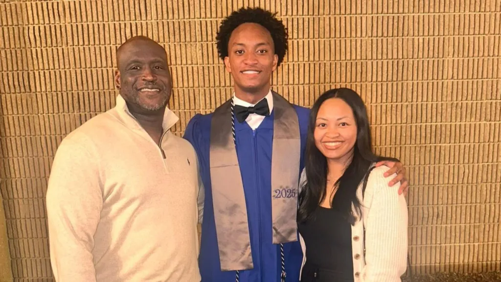 Nolan Wells in his graduation gown standing between his mother, Christine Wonsley, and father, Elmore Wonsley.