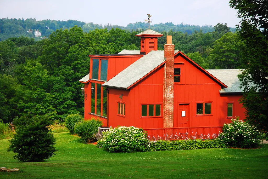 Norman Rockwell's red studio with a cupola and weathervane, nestled in the Berkshire Mountains.
