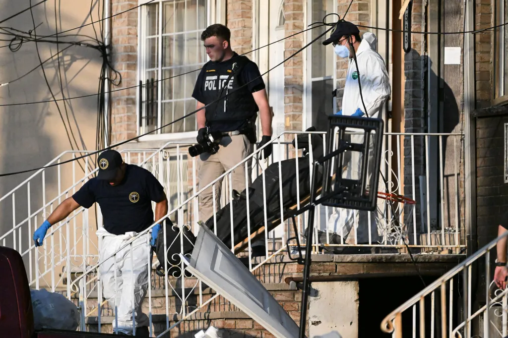 Police and medical examiner personnel at a crime scene.
