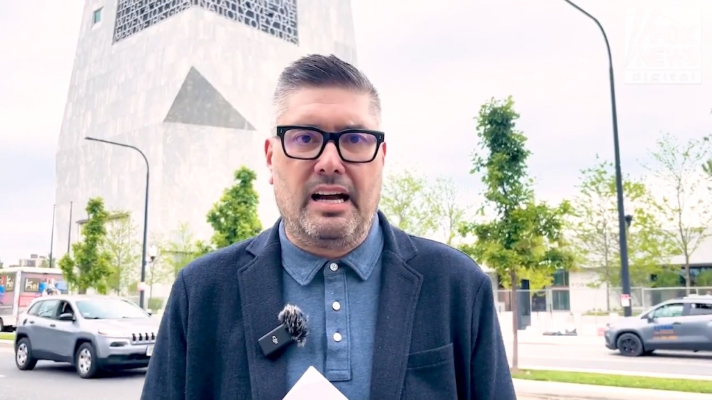 Mike Owen, owner of Adamson Plumbing, speaking in front of the Obama Center construction site.