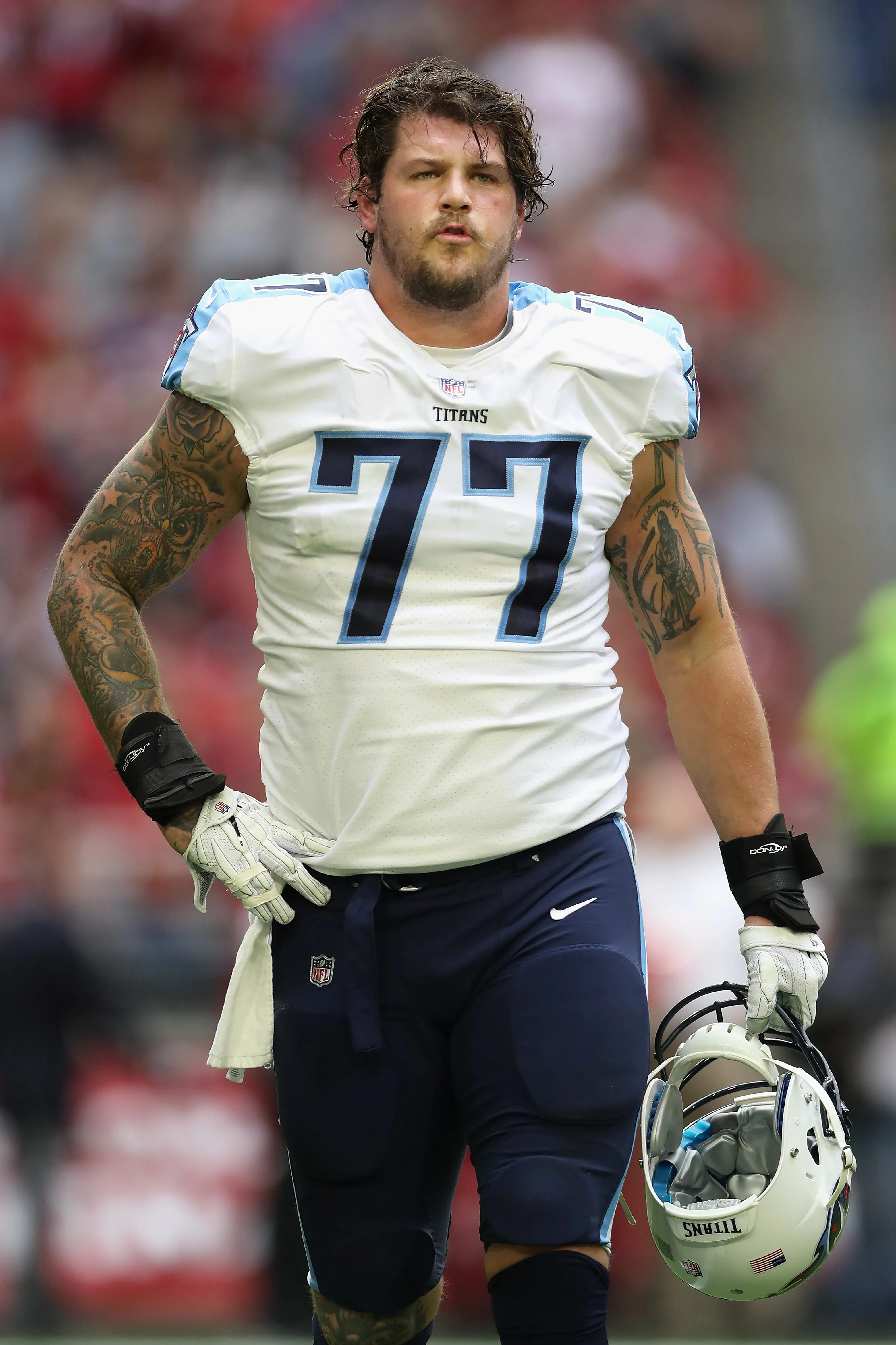 Offensive tackle Taylor Lewan #77 of the Tennessee Titans walks on the field.