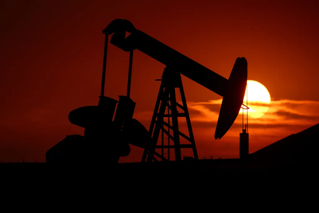 An oil well pumpjack is silhouetted against a setting sun in Oklahoma City.