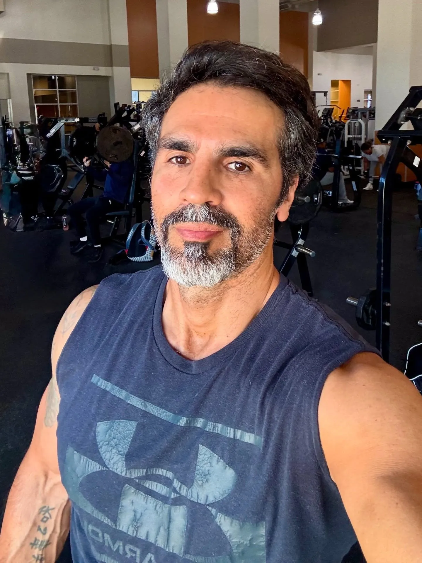 Ojani Noa posing for a selfie in a gym.