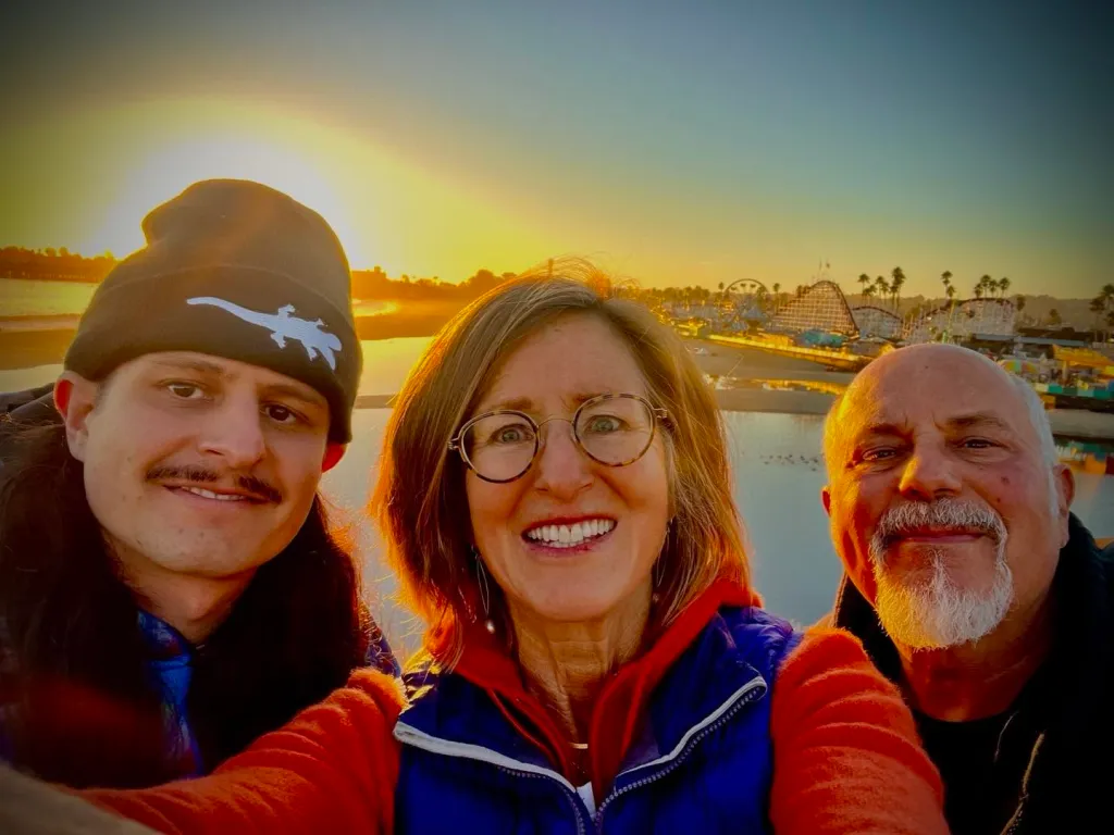 Oliver Tree, his mother, and his father pose for a selfie at sunset.