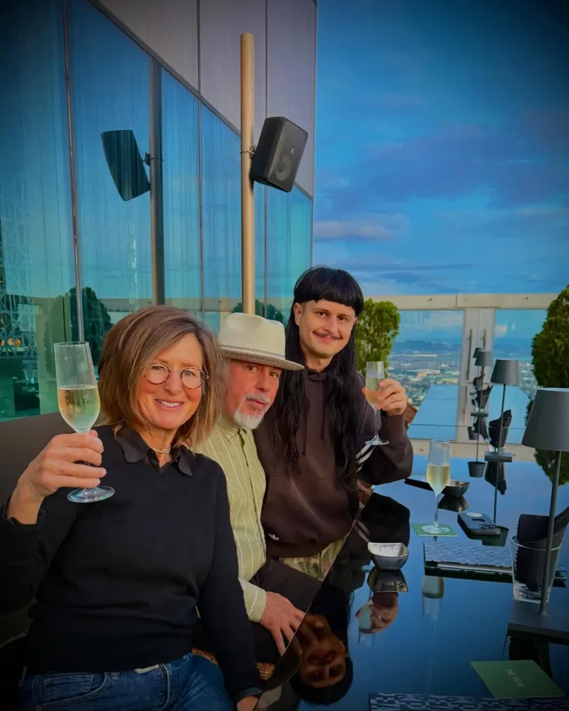 Oliver Tree with his family holding glasses of champagne.