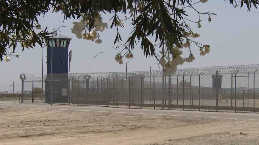 North Kern State Prison in Delano, California, with fences topped with razor wire and a guard tower.