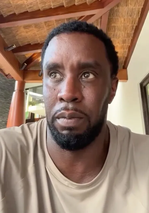 P. Diddy looking up with a somber expression.
