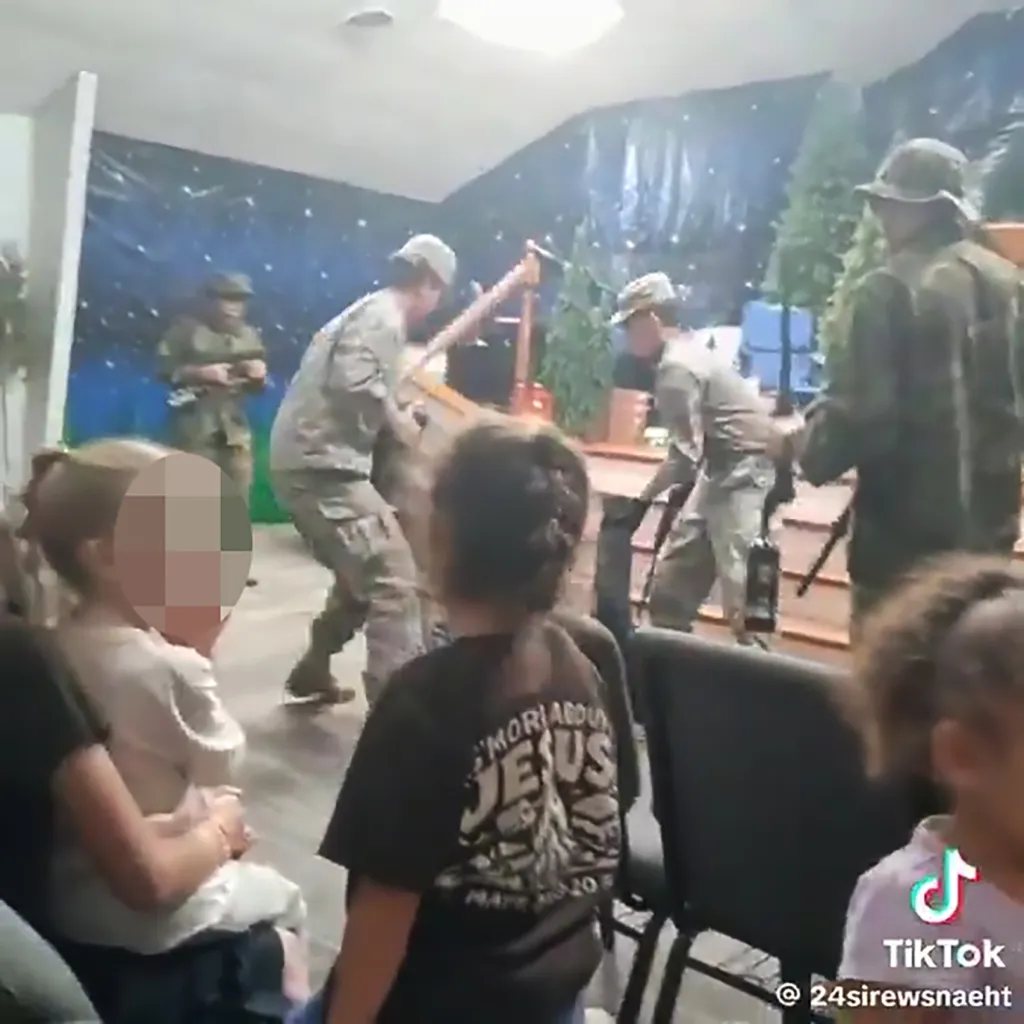 Men in military-style costumes performing a mock firing squad in front of children.