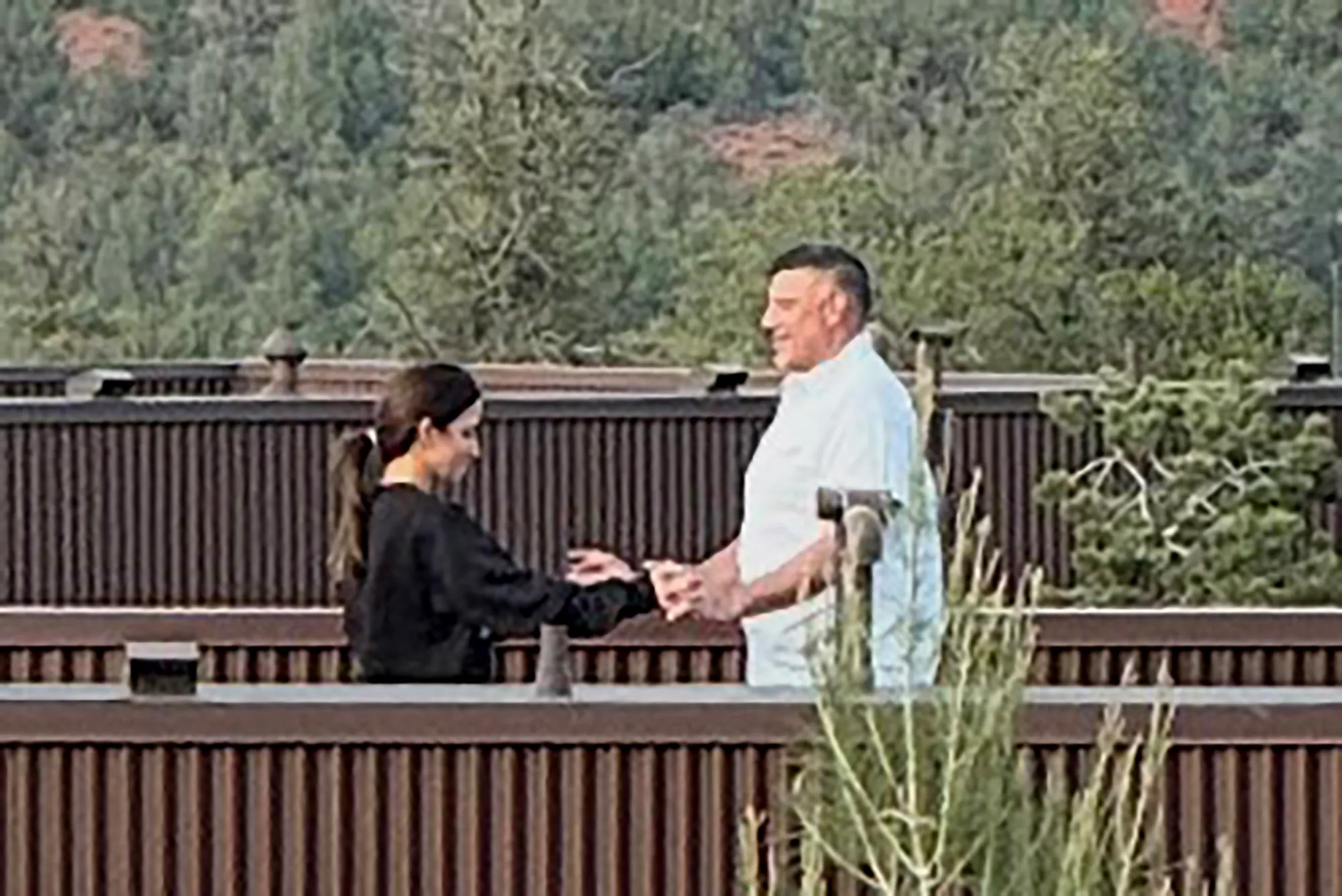 Mike Vrabel and Dianna Russini holding hands.