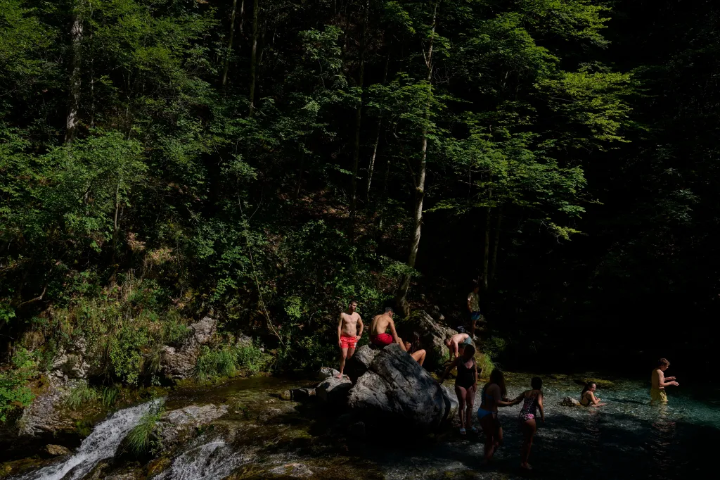 People cooling off in the clear water of the Enipeas Gorge on Mount Olympus in Greece.