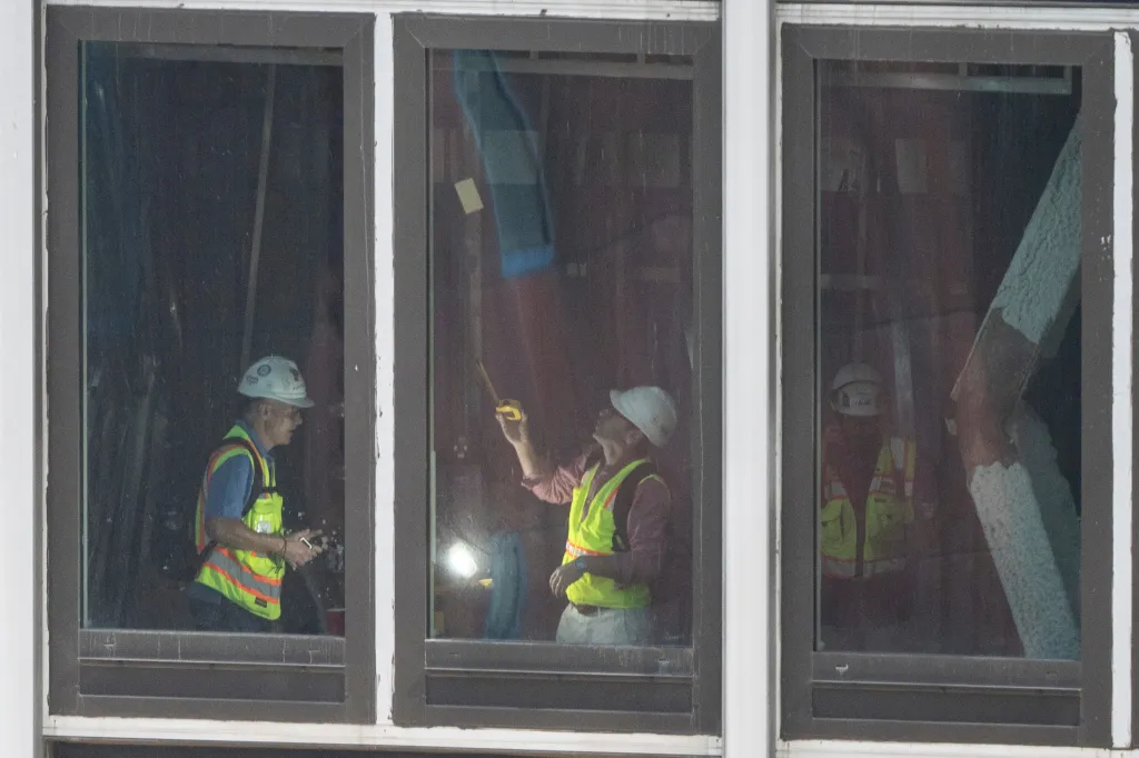 Inspectors seen surveying a buckled support beam inside 235 E. 42nd St. on Wednesday.