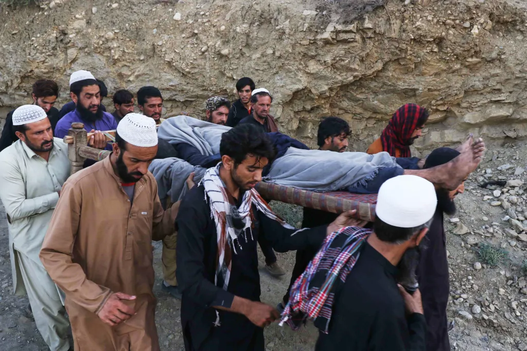 Men transporting the body of a miner after a coal mine explosion in Pakistan.