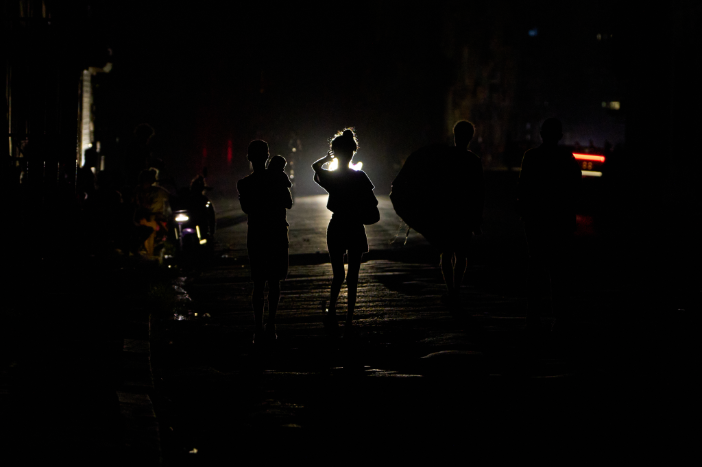 People walk along a street during a blackout in Havana, Cuba, on July 6, 2026.