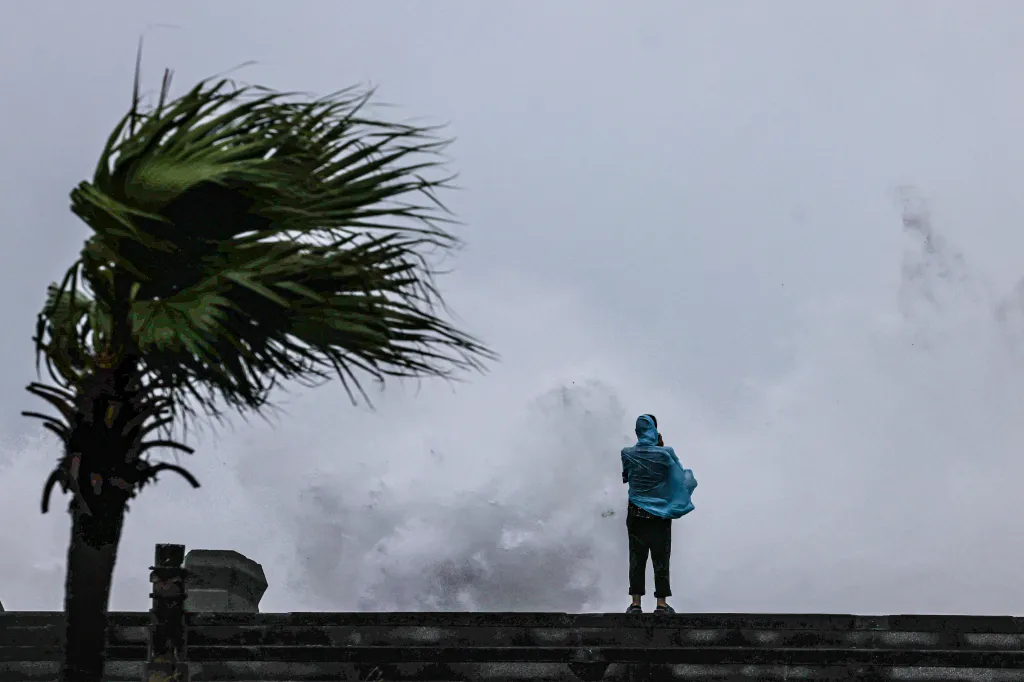 A person watches large waves crash during Typhoon Bavi in Taiwan on July 11, 2026.