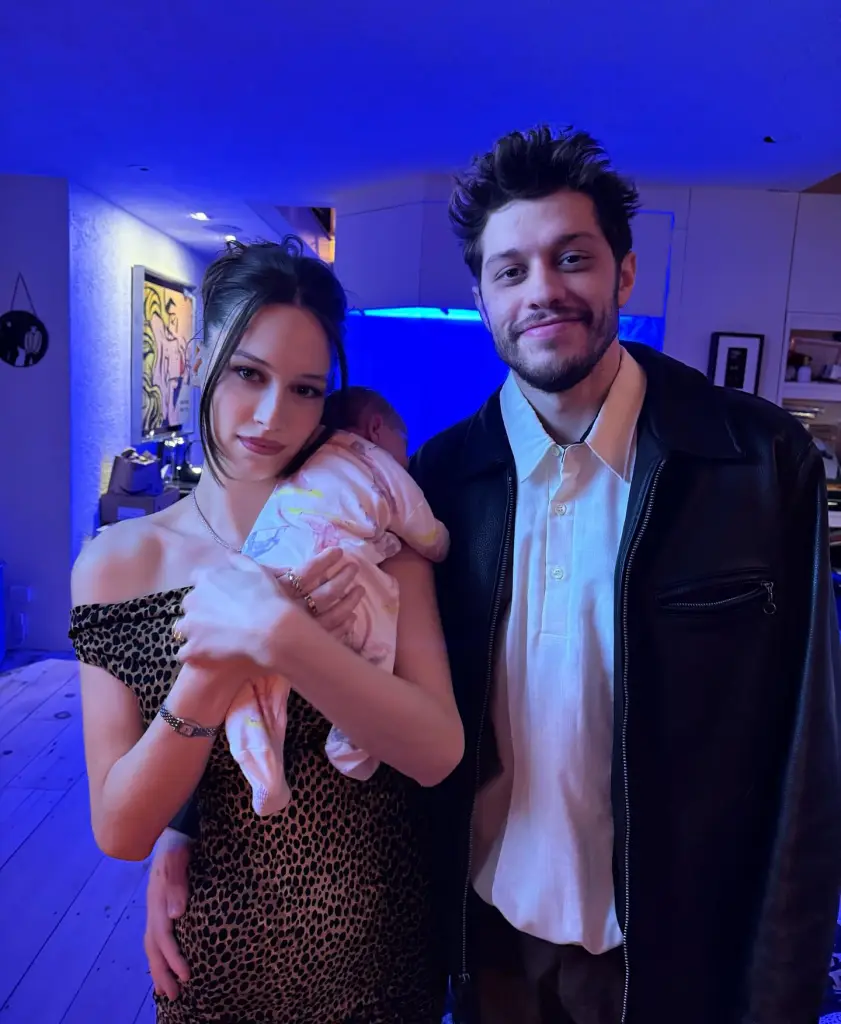 Pete Davidson, Elsie, and a baby pose for a photo.