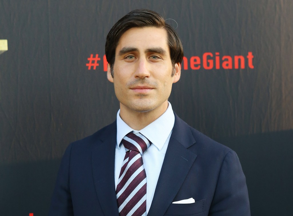 Peter Nelson, in a navy blue suit and maroon and blue striped tie and blue shirt, at the HBO World Premiere of "Andre The Giant".