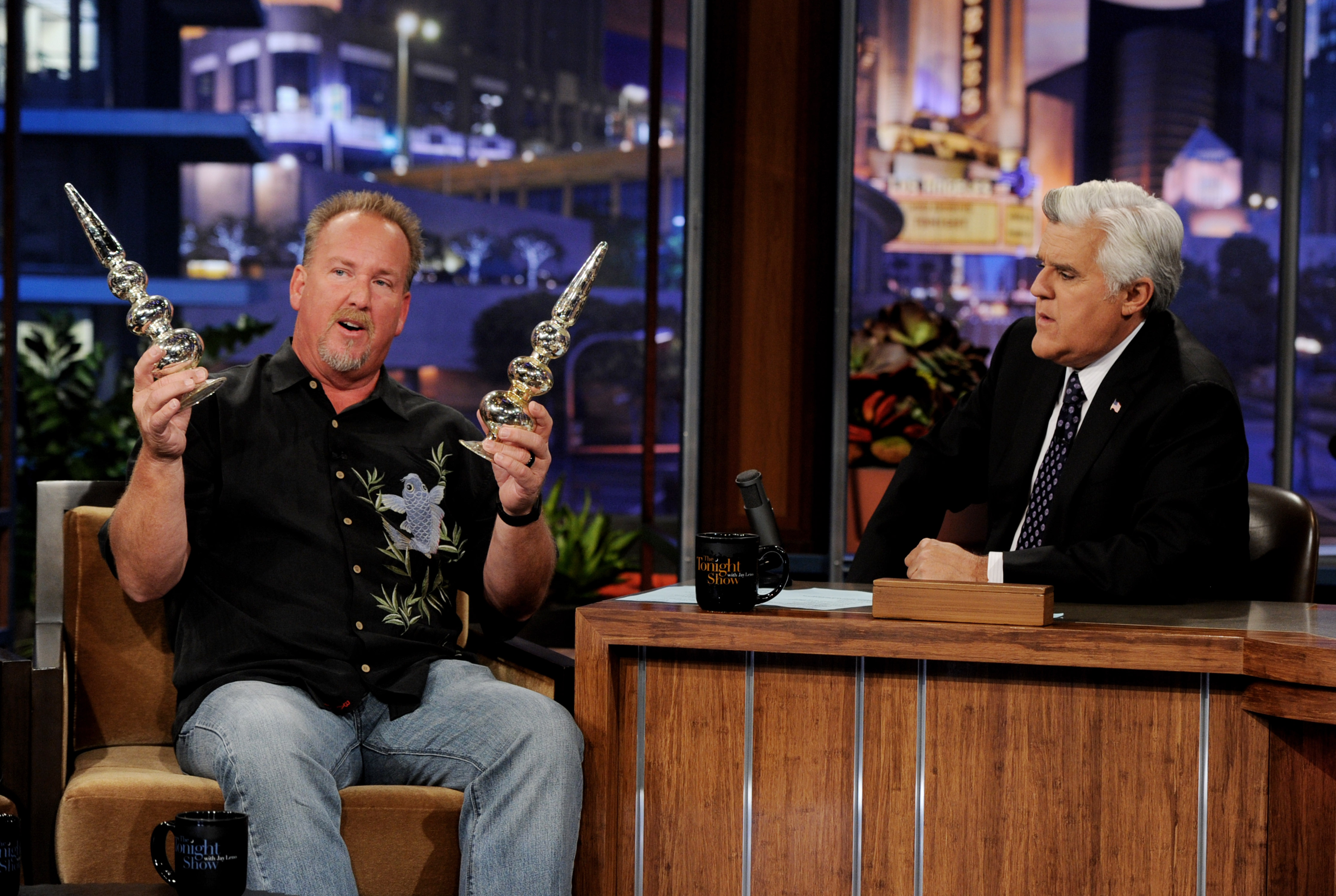 Darrell Sheets showing two silver finials to Jay Leno on "The Tonight Show."