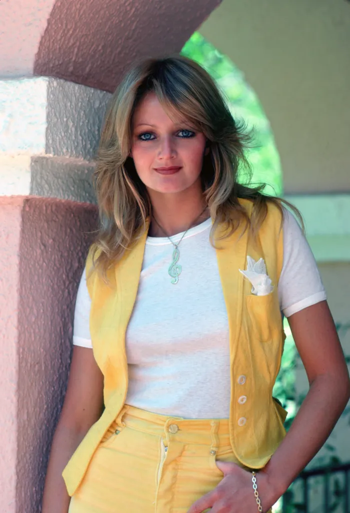 Bonnie Tyler standing and looking at the camera.