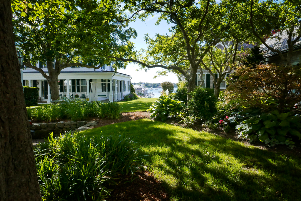 White house with a porch and columns overlooking Katama Bay.