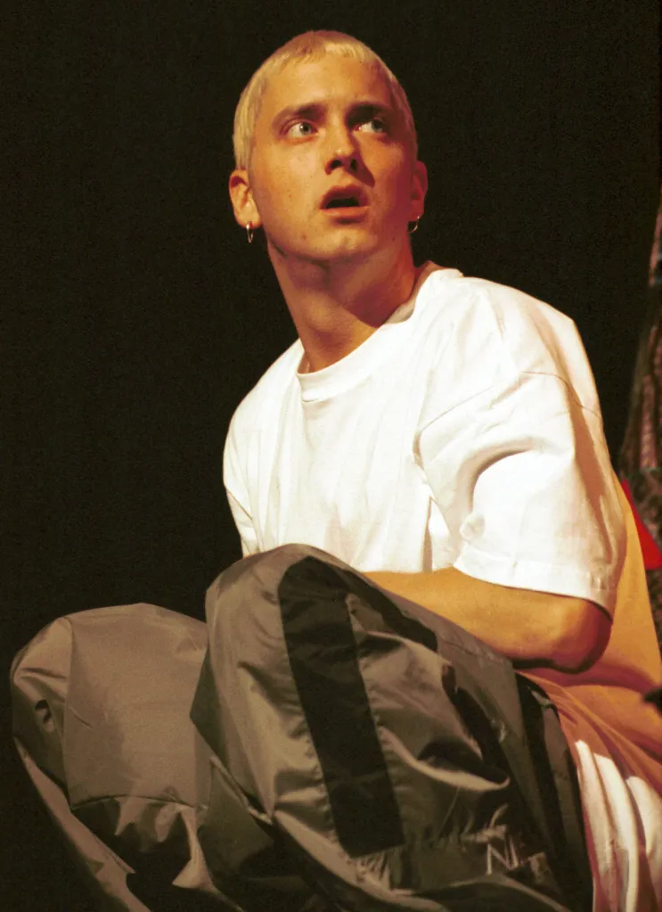 Eminem performing live at a concert.