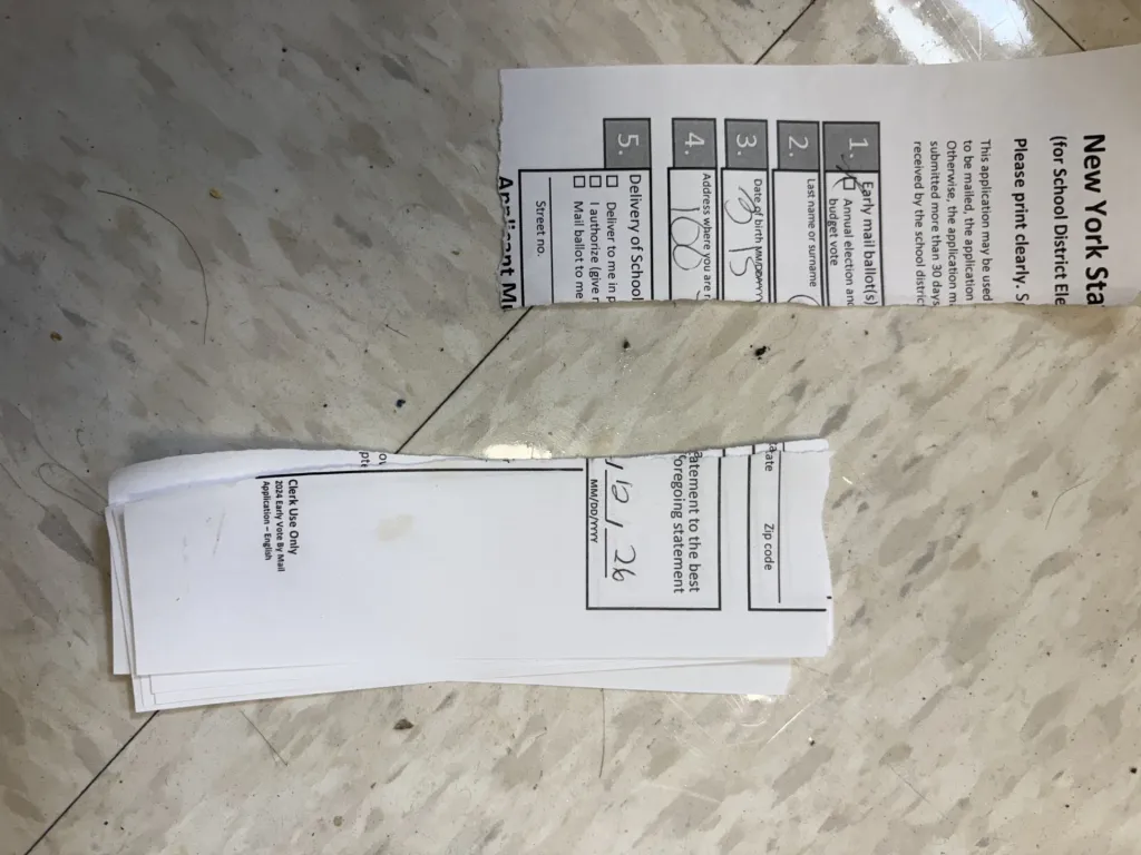 Torn New York State early mail ballot application forms.