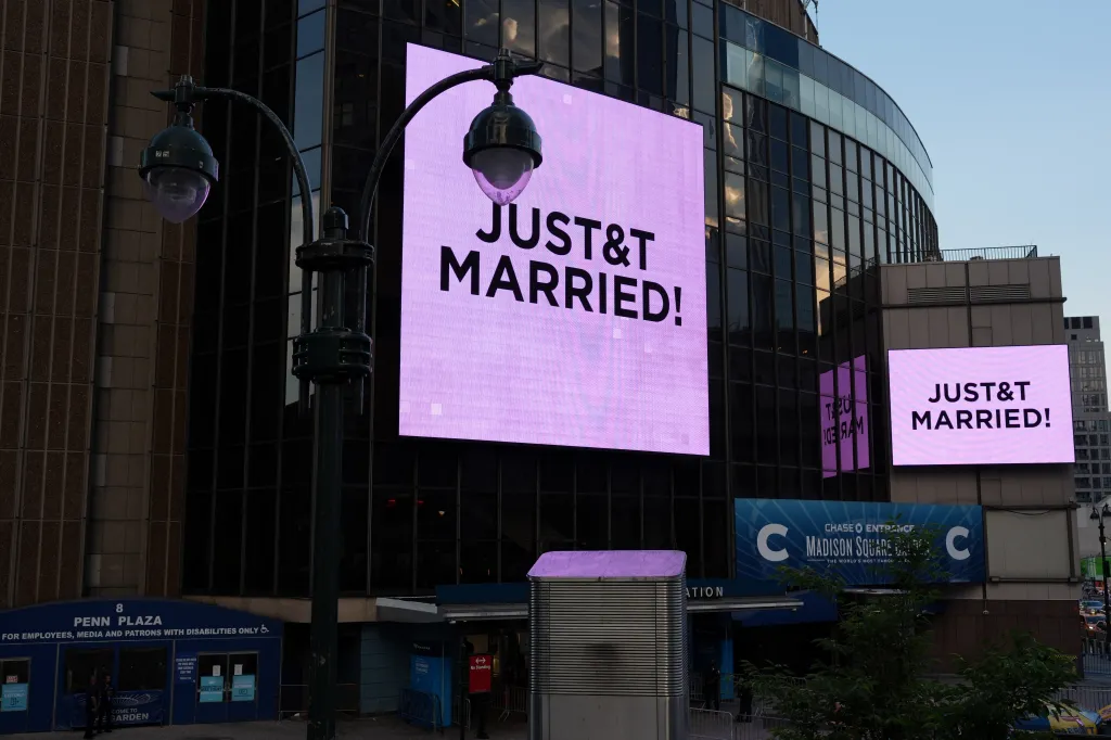 Screens outside Madison Square Garden display the message "JUST&T MARRIED!", referencing Taylor Swift and Travis Kelce.