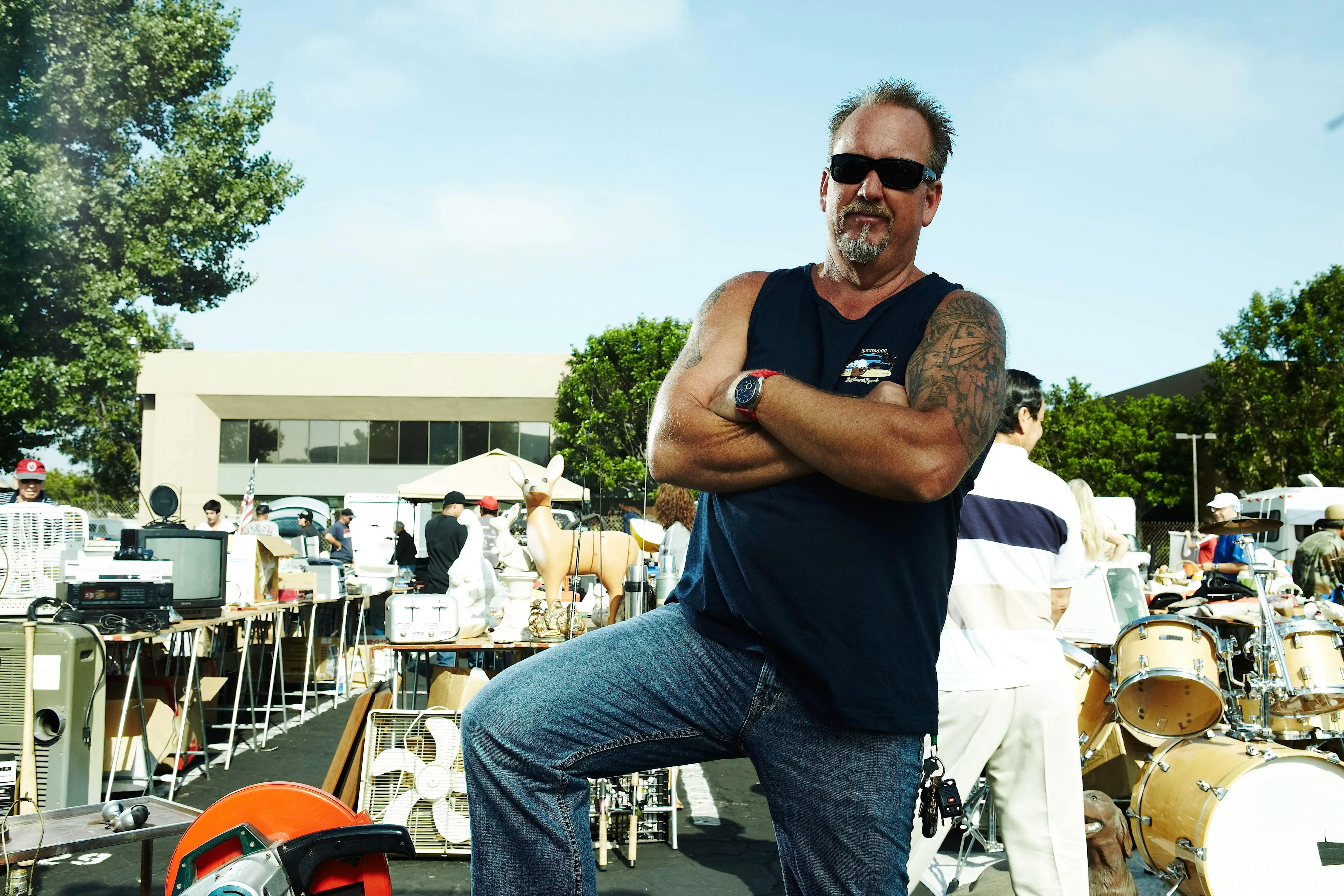 Darrell Sheets from Storage Wars poses at an outdoor market.