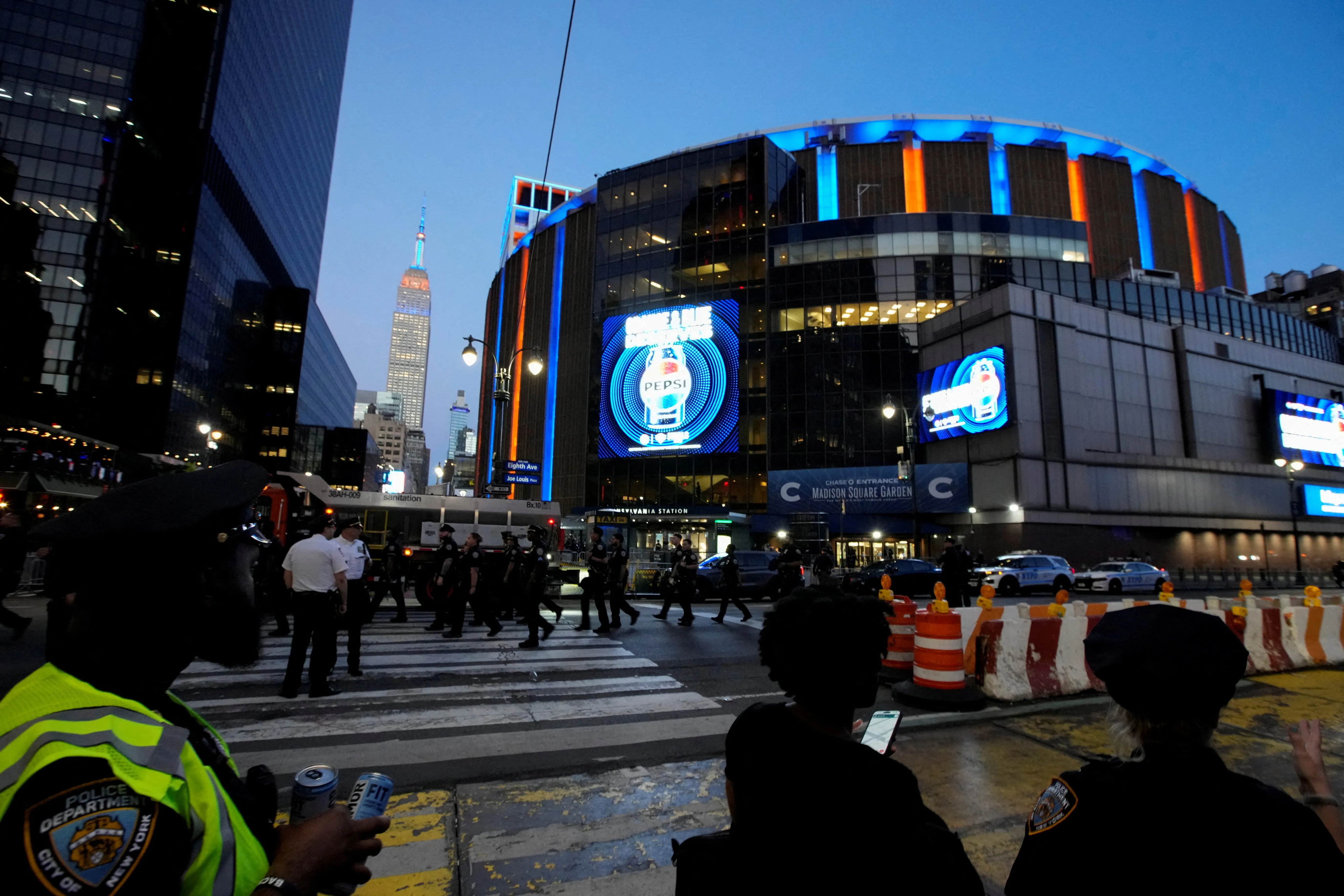 The Empire State Building and Madison Square Garden lit up in Knicks colors for the NBA Finals.